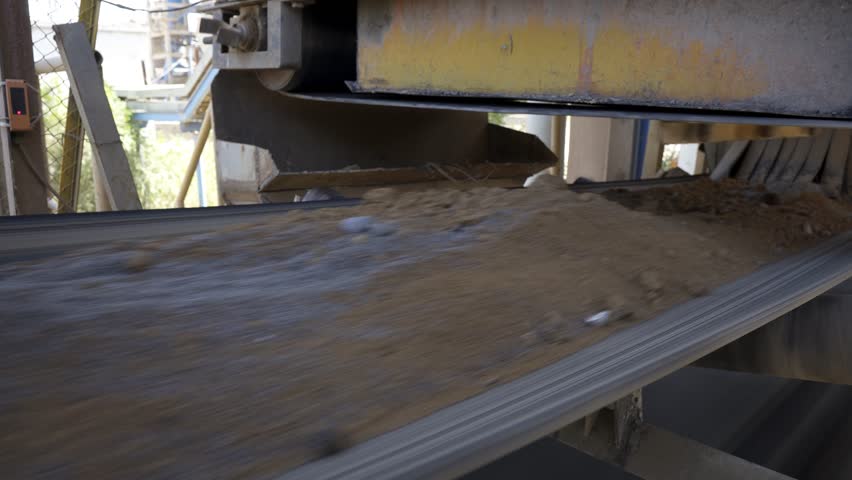Cement factory. Conveyor with stones and gravel, tunnel. Сement flour. Modern technologies work at the cement plant. Technological work on the production of cement. Working atmosphere with copy space. | Shutterstock HD Video #1098968913