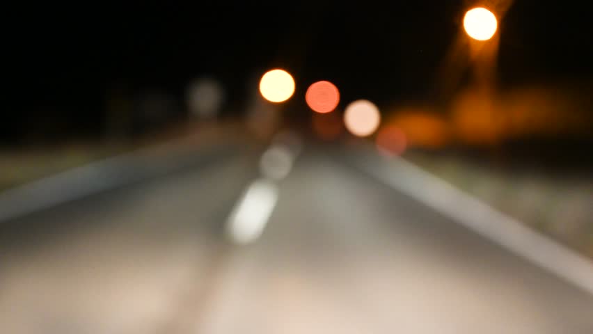 A drunk driver drives a car at night. Dangerous driving.