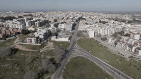 Altamura, Italy skyline with highway and traffic with drone video moving left to right.