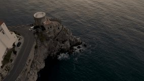 Amalfi, Italy at sunrise with drone video at sunrise with reveal of castle and sea.