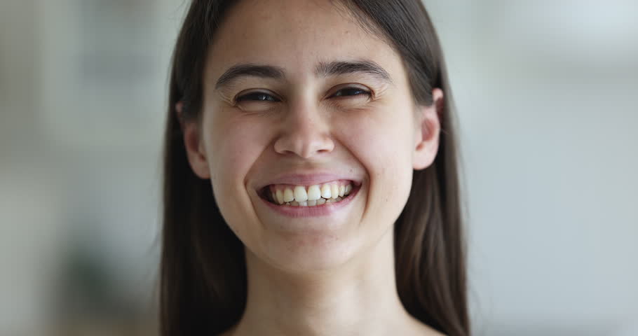 Eyesight and vision correction professional services clinic advertisement. Close up face of beautiful young woman smile looking at camera having wide toothy smile advertise dental clinic procedures | Shutterstock HD Video #1098976603