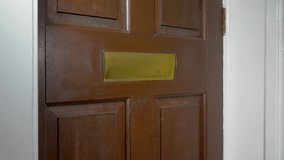 Letters and small packages being posted through the brass letterbox of an old wooden front door, viewed from the inside. - Powered by Shutterstock - Get 15% off with code: PIKWIZARD15