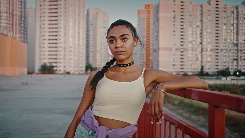 Modern young woman portrait. Cool african american lady wearing trendy looking at camera outdoors, feeling self confident in urban area, slow motion | Shutterstock HD Video #1098983427
