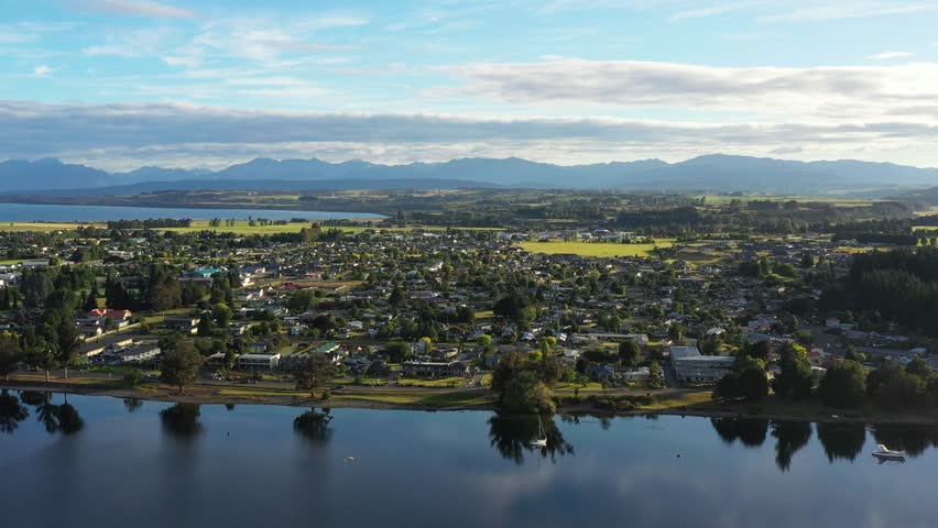 Mirror Te Anau town waterfront reflecting in Te Anau lake of New Zealand 4k.
