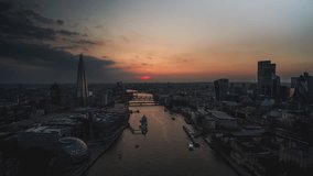 Establishing Aerial View Shot of London UK, United Kingdom, Marvellous Tower Bridge, very moody beautiful sunset, pull out reveal