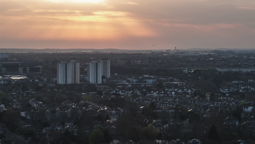 Establishing Aerial View Shot of London UK, United Kingdom, sunset, Twickenham, Feltham,  Hounslow, plane landing at Heathrow Airport Royalty-Free Stock Footage #1098989187