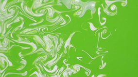 White paint on green paint dissolves, the abstract background is beautiful for different video editing.