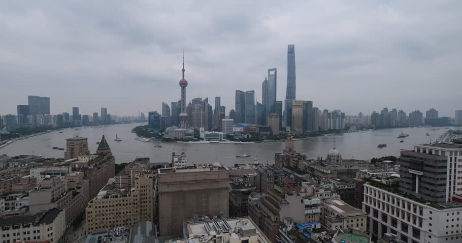 wide angle of Shanghai city landmarks and Huangpu river on overcast cloudy day. High angle view establishing shot