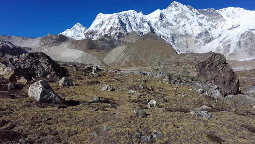 Gokyo, Nepal: Point of view of an hiker walking toward the Gokyo 6th lake, frozen in winter, and the Cho Oyu base camp, in the Himalayas in the Khumbu Everest region in Nepal. 