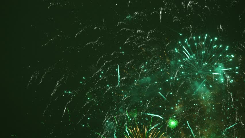 Fireworks at night after celebration. The colors are yellow and green | Shutterstock HD Video #1099003285