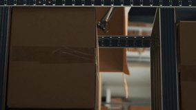 Vertical video: Storehouse filled with raw materials on shelves to put carton packages, preparing boxes with merchandise and goods for shipment and delivery. Empty storage space used as small business