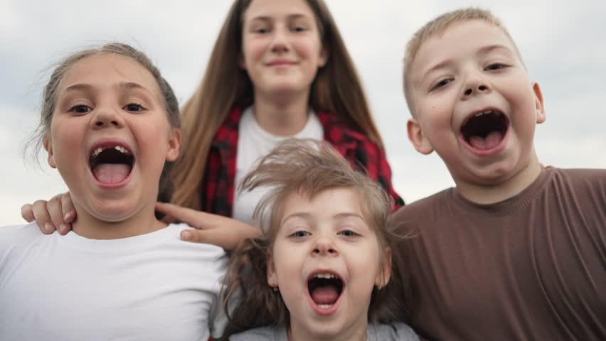 Children play in park.Happy family concept. Faces of kid in camera. Children jump hugging. Happy kid laughing in park. Jumping and joy of children. Happy family at sunset. Happy faces close up in park | Shutterstock HD Video #1099009109