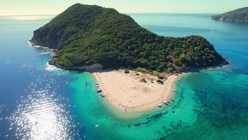 Aerial view of Marathonisi Island near Zakynthos island in Greece. Marathon island at sunrise in Zante, Ionian sea. Drone orbit shot