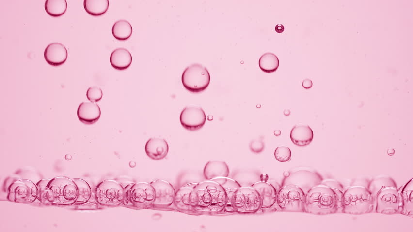 Background shot for skin care products with rose oil commercial | Macro shot of a lot of different sized transparent bubbles of rose oil go down to another ones on pale pink background Royalty-Free Stock Footage #1099012707