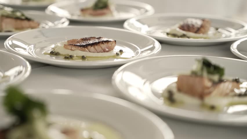 Master chef preparing delicious salmon meal in white plates, close up view | Shutterstock HD Video #1099014449