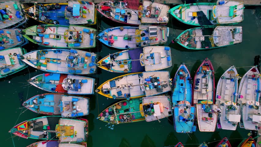 Fishing boats in a small port in Mirissa. Colorful boats are standing at the pier. Drone video shot. | Shutterstock HD Video #1099019039