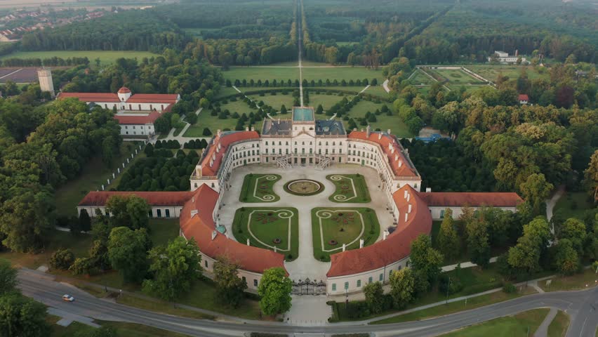 Fertod, Hungary - 4K Aerial view of Eszterhazy Palace near Sopron. Flying over Eszterhazy castle and garden on a bright summer morning at sunrise