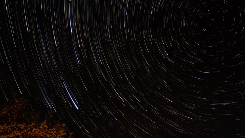 Stars leave trails in the night sky around the Pole star. Rotation of the constellations is due to the rotation of the Earth. Long exposure astrophotography