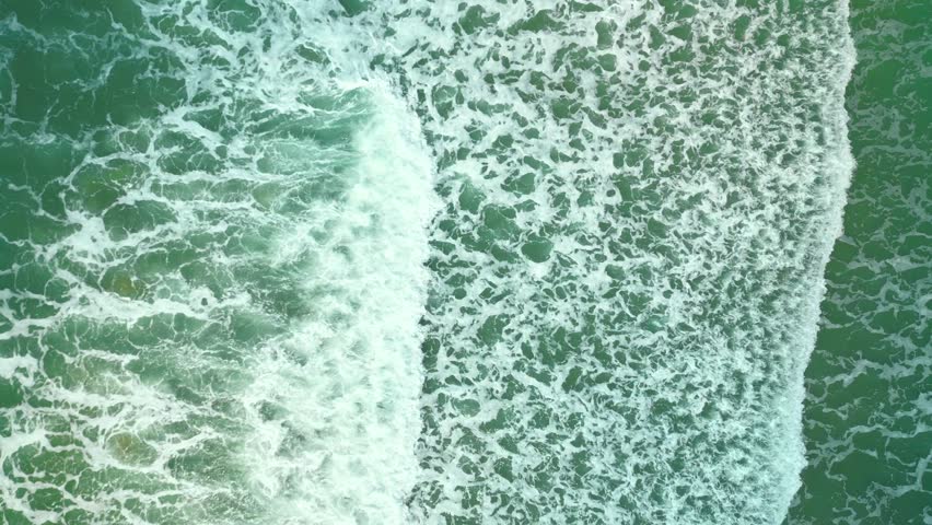 Beautiful texture of big power dark ocean waves with white wash. Aerial top view footage of fabulous sea tide on a stormy day. Drone filming breaking surf with foam in Vietnam ocean. Big swell in Asia | Shutterstock HD Video #1099029295