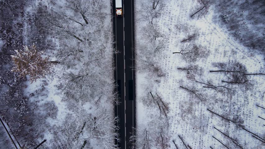 Truck driving winter ice road, aerial view. Business logistic import and export freight transportation