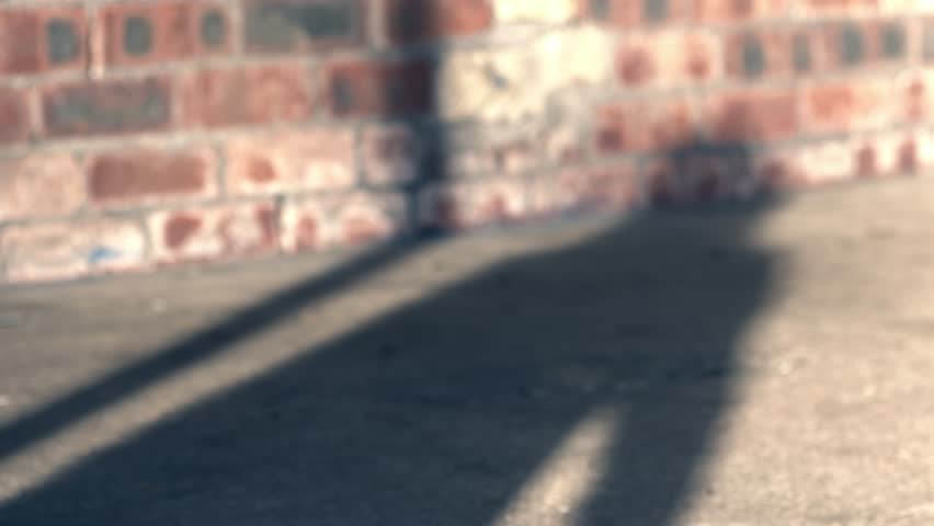 Shadow of woman waving on brick building background medium slow motion shot selective focus