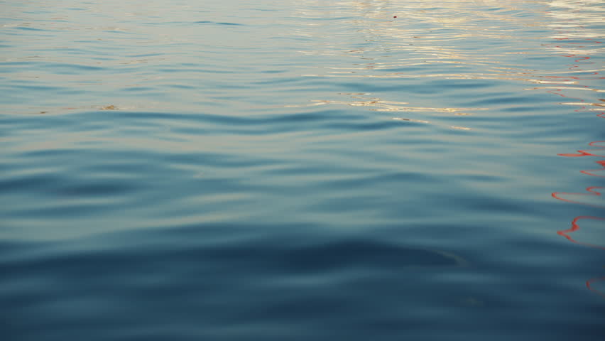 Blue texture water surface small waves slow motion move form ripples at sunset in summer evening. Nature.  Royalty-Free Stock Footage #1099030569