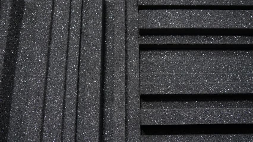 Acoustic foam tiles. A tracking shot of square cut sound proofing music studio diffusion foam panels | Shutterstock HD Video #1099030787