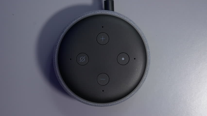 Overhead shot of smart speaker activated by voice command control with blue light ring | Shutterstock HD Video #1099030803