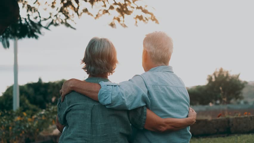 Head shot close up portrait happy grey haired middle aged woman snuggling to smiling older husband, enjoying tender moment at park. Bonding loving old family couple embracing, feeling happiness.
 | Shutterstock HD Video #1099031307