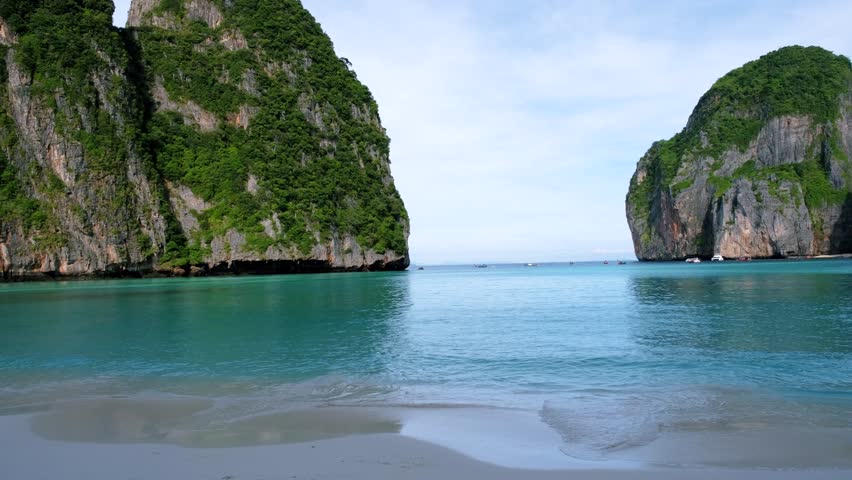 Limestone cliffs and tropical beach at the lagoon of Maya Bay Koh Phi Phi Thailand. Tropical Island in Thailand | Shutterstock HD Video #1099031899