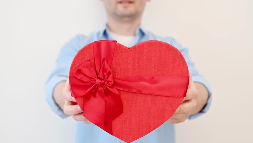 	
Happy man holding heart-shaped gift box.Anniversary,valentines day,8 march Royalty-Free Stock Footage #1099032949