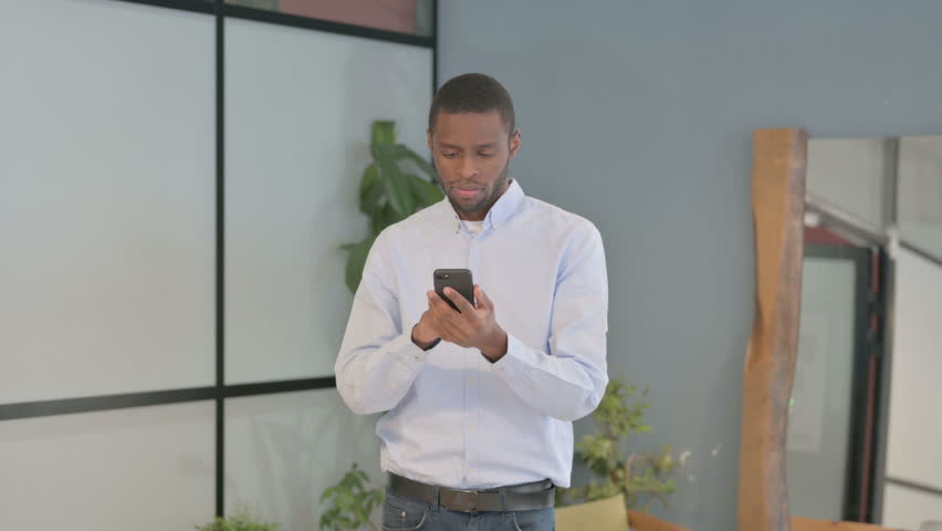 African American Man Talking on Phone, Discussing Work