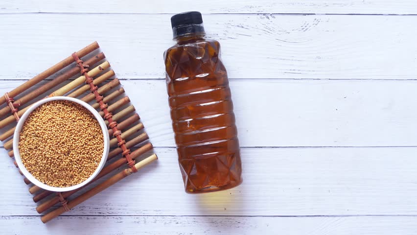 sunflower coking oil and seeds in a container on table 