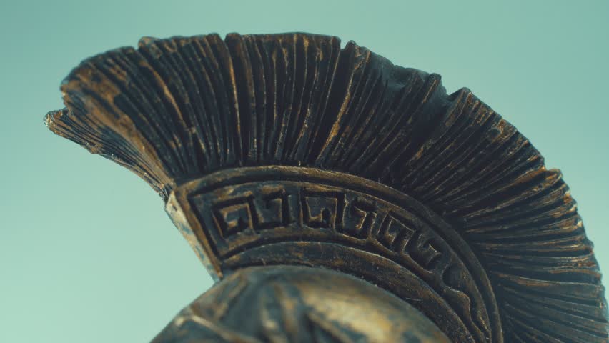 A rotating close up macro shot of a spartan warrior metal bronze ancient greek helmet, with shapes and forms, studio lighting, slow motion, 4K video Royalty-Free Stock Footage #1099038879