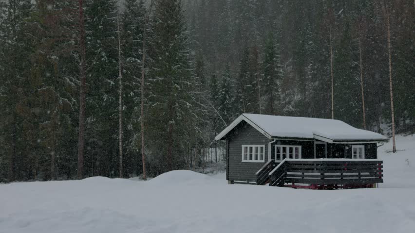 Cabin in the woods in heavy snow Norway