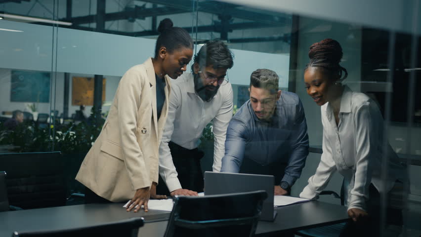 Multiracial business team group of workers developers managers looking at laptop in office celebrating success victory good news put palms up partnership unity gesture good investment financial profit | Shutterstock HD Video #1099041867
