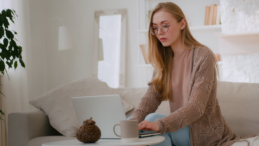 Caucasian shocked girl in glasses feel shock reading bad news woman lost with laptop worry about loosing online with computer terrible information mail Internet app problem business failure at home Royalty-Free Stock Footage #1099041897