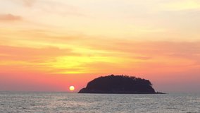 scenery yellow sun going down to the sea.
beautiful moving cloud in sweet sky at sunset in Kata beach Phuket Thailand
4k stock footage video in travel concept.