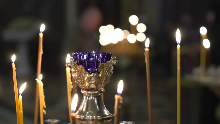 Candles are burning during a church service | Shutterstock HD Video #1099045491