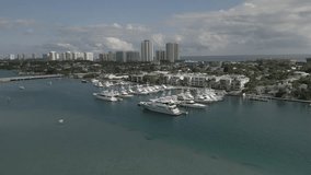 This 4K aerial drone footage offers a unique and visually stunning perspective of boats and yachts moored at the dock, located along the Florida Intracoastal Waterway.