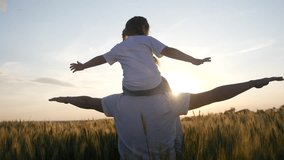 happy family silhouette teamwork concept slow motion video. daughter little girl sitting on his father man neck depicts a flight of an airplane playing a pilot. dad and child kid daughter lifestyle