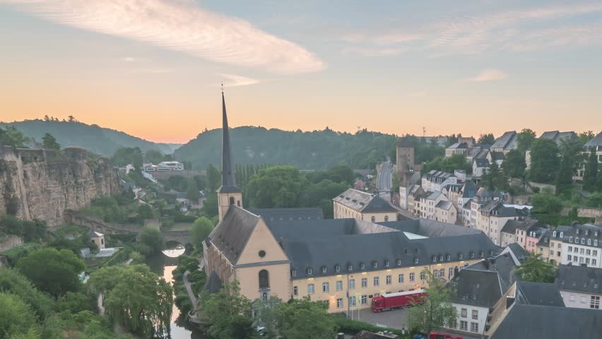 Grand Duchy of Luxembourg time lapse 4K, city skyline night to day sunrise timelapse at Grund along Alzette river in the historical old town of Luxembourg
