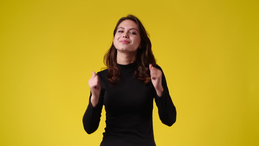 4k video of one girl showing thumbs up over yellow background. | Shutterstock HD Video #1099056495