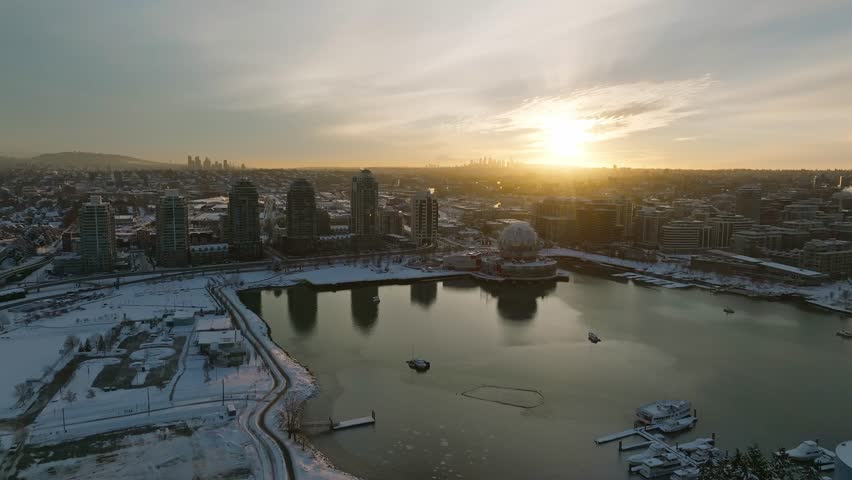 Vancouver Drone Aerial Moving shot of the ASTC Science World globe building covered in snow - Canada