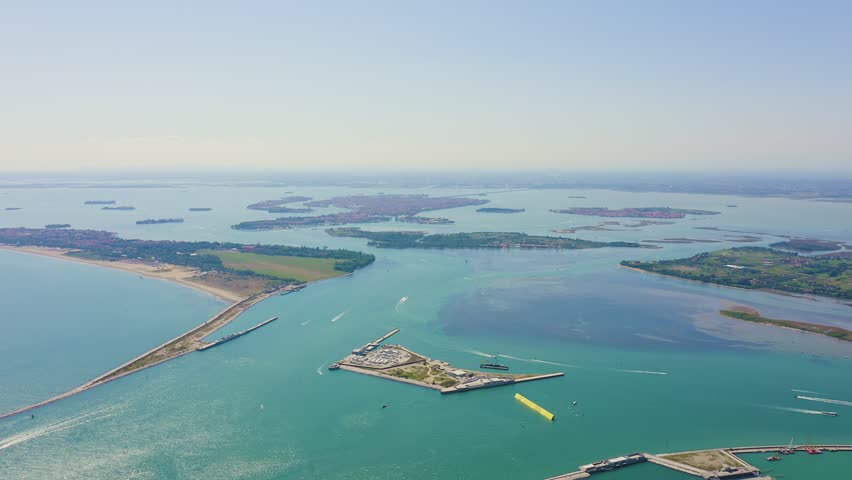 Inscription on video. Venice, Italy. General view of the city and islands of Venice. Venetian lagoon. Clear sunny weather. On the mechanical display, Aerial View