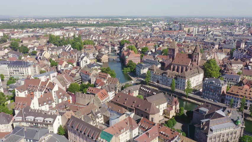 Inscription on video. Strasbourg, France. Historic City, Ill River. Multicolored text appears and disappears, Aerial View, Departure of the camera