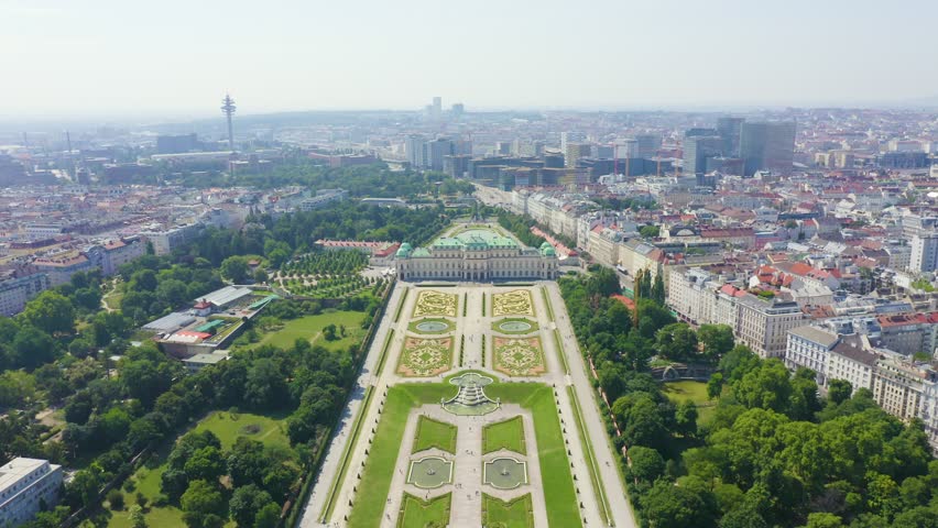 Inscription on video. Vienna, Austria. Belvedere is a baroque palace complex in Vienna. Built by Lucas von Hildebrandt at the beginning of the 18th century. Neon white effect text, Aerial View, Depar