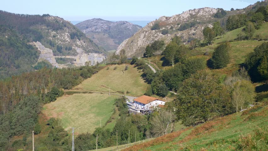 Landscape of a House at the mountain surrounded by field and trees 