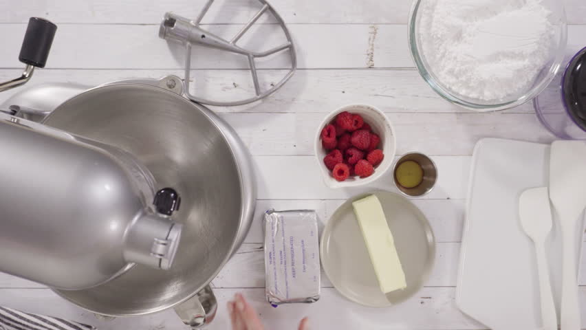Flat lay. Preparing raspberry cream cheese buttercream in kitchen mixer for bake chocolate raspberry cupcakes.