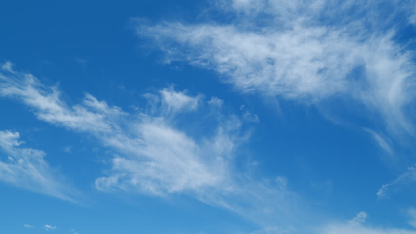 Blue sky with white cirrus clouds. Sunny background, blue sky with white cirrus clouds. Time lapse. Royalty-Free Stock Footage #1099076647
